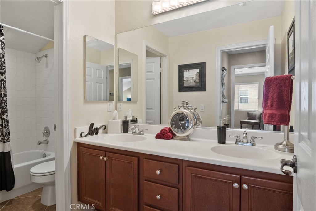 3837 Grandview Drive Brea, CA 92823 - Photo 62 of 72 a bathroom with a double vanity sink toilet and a mirror