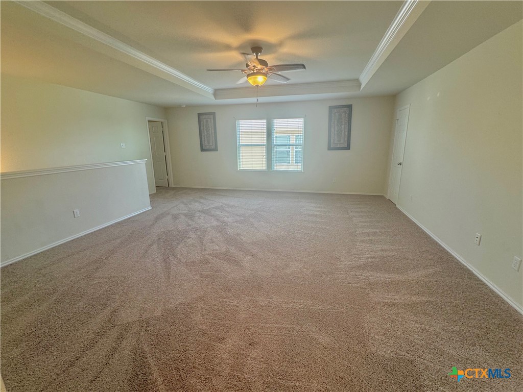 3101 Shawlands Road Killeen, TX 76542 - Photo 21 of 41 en empty room with windows and chandelier fan