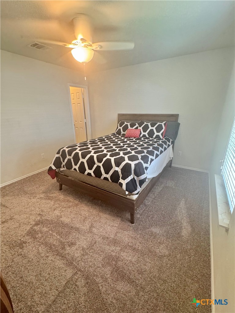 3101 Shawlands Road Killeen, TX 76542 - Photo 23 of 41 a bed sitting in a bedroom next to a window and a chandelier