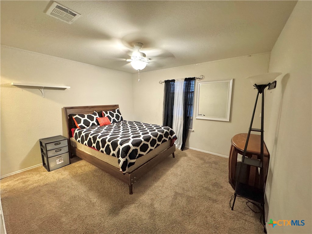 3101 Shawlands Road Killeen, TX 76542 - Photo 27 of 45 a bedroom with a bed and a chandelier