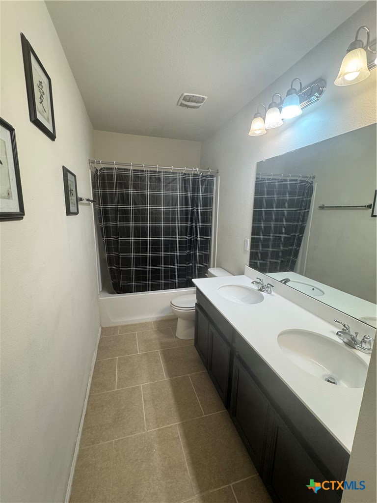 3101 Shawlands Road Killeen, TX 76542 - Photo 30 of 41 a bathroom with a double vanity sink a toilet and a mirror