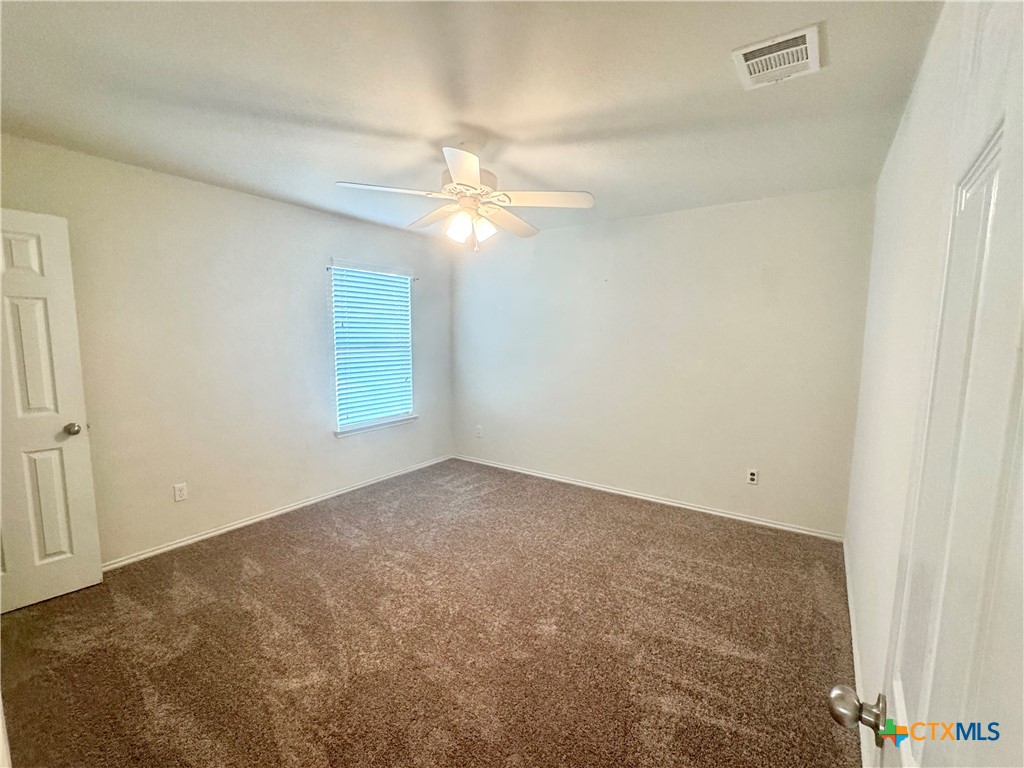 3101 Shawlands Road Killeen, TX 76542 - Photo 35 of 41 an empty room with a window and ceiling fan
