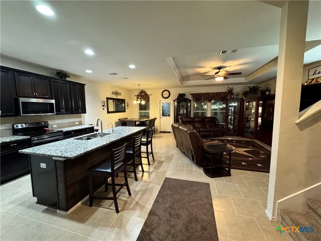 a kitchen with stainless steel appliances granite countertop a stove and a refrigerator