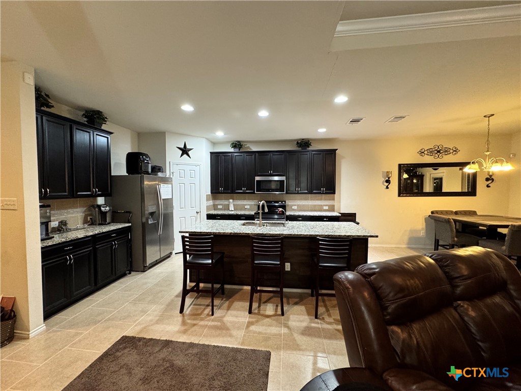 3101 Shawlands Road Killeen, TX 76542 - Photo 8 of 45 a living room with stainless steel appliances kitchen island granite countertop furniture a refrigerator and a stove top oven