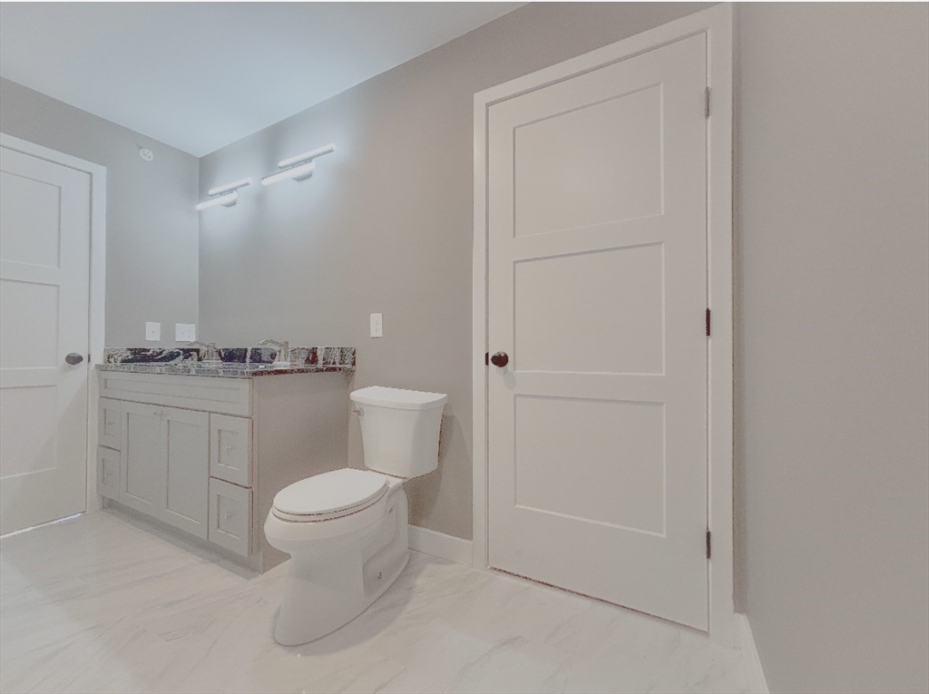 56 Richards Street Worcester, MA 01603 - Photo 19 of 24 a white toilet sitting next to a bathroom sink