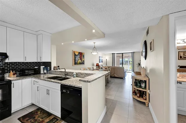 a kitchen with a dining table chairs and refrigerator