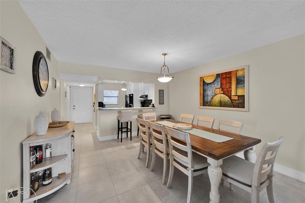 3591 Environ Boulevard, Unit A305 Lauderhill, FL 33319 - Photo 20 of 73 a view of a dining room with furniture