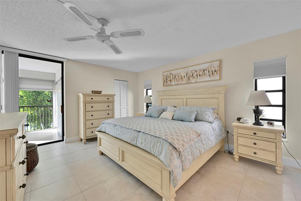 3591 Environ Boulevard, Unit A305 Lauderhill, FL 33319 - Photo 27 of 73 a bedroom with a bed and a dresser