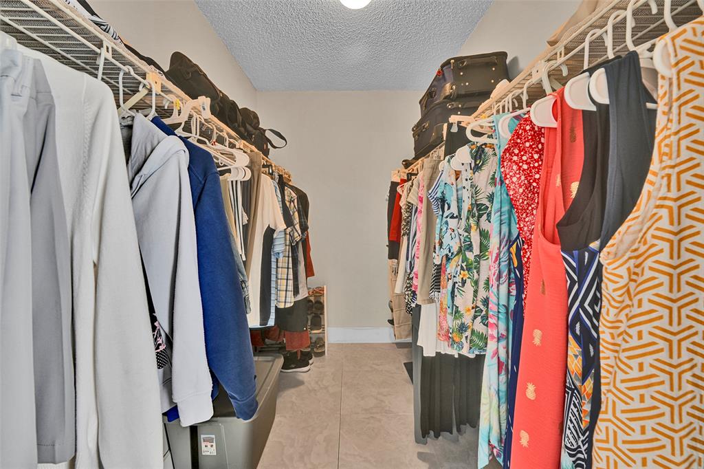 3591 Environ Boulevard, Unit A305 Lauderhill, FL 33319 - Photo 30 of 73 a view of walk in closet with clothes and shoes