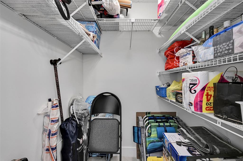 3591 Environ Boulevard, Unit A305 Lauderhill, FL 33319 - Photo 32 of 73 a view of walk in closet with clothes and shoes