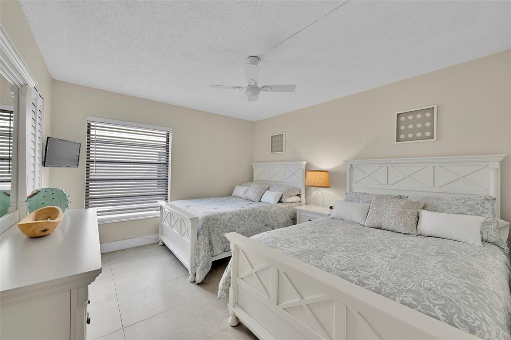 3591 Environ Boulevard, Unit A305 Lauderhill, FL 33319 - Photo 34 of 73 a bedroom with two beds and painting on the wall