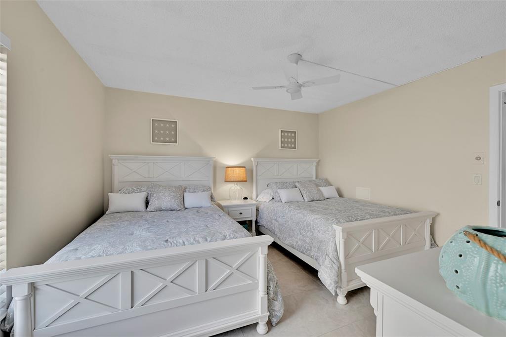 3591 Environ Boulevard, Unit A305 Lauderhill, FL 33319 - Photo 35 of 73 a bedroom with a bed and wooden floor