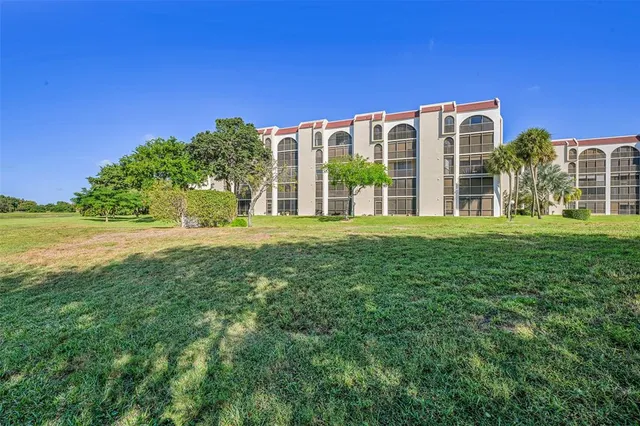 an aerial view of residential houses with outdoor space and swimming pool