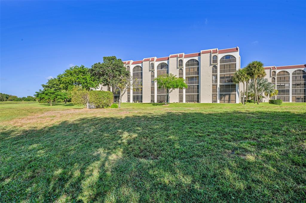 3591 Environ Boulevard, Unit A305 Lauderhill, FL 33319 - Photo 44 of 73 a view of a building with a yard