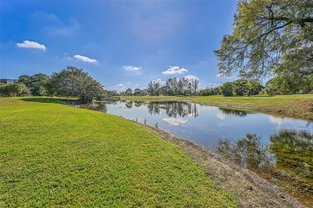 3591 Environ Boulevard, Unit A305 Lauderhill, FL 33319 - Photo 45 of 73 a view of a lake with houses in the back