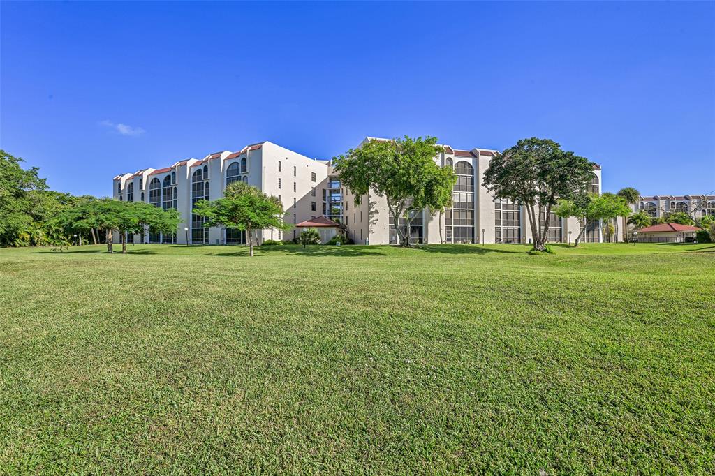 3591 Environ Boulevard, Unit A305 Lauderhill, FL 33319 - Photo 70 of 73 a front view of a building with a big yard