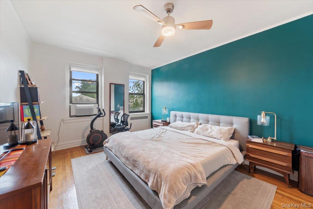 167 Centre Avenue, Unit 3E New Rochelle, NY 10805 - Photo 12 of 15 a bedroom with a bed wooden floor and window