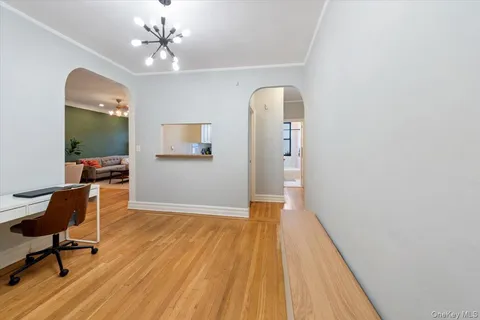 a view of kitchen and hallway with wooden floor