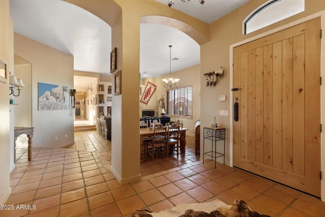 a kitchen with stainless steel appliances granite countertop a refrigerator a stove and a sink with wooden floor