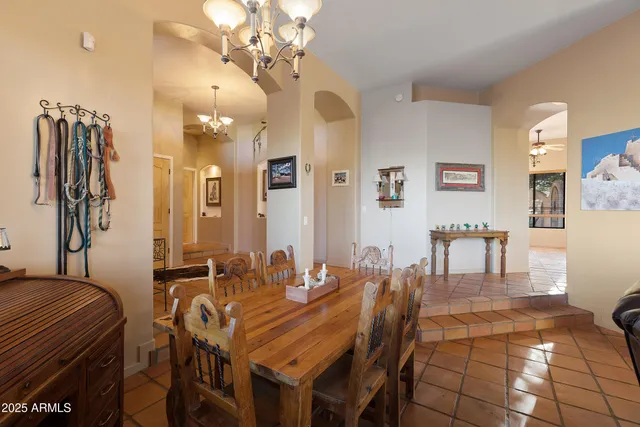 a bath tub sitting next to a blue sink and a shower