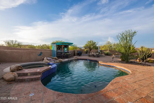 an aerial view of a city with lots of residential buildings and mountain view in back