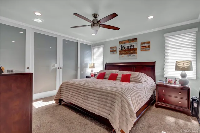 a bathroom with a granite countertop sink a toilet a mirror and bathtub