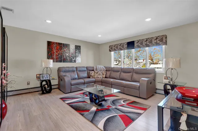 a kitchen with stainless steel appliances granite countertop a stove and a wooden floors