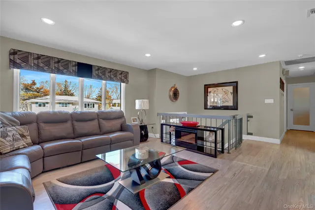a view of a kitchen area with furniture and wooden floor
