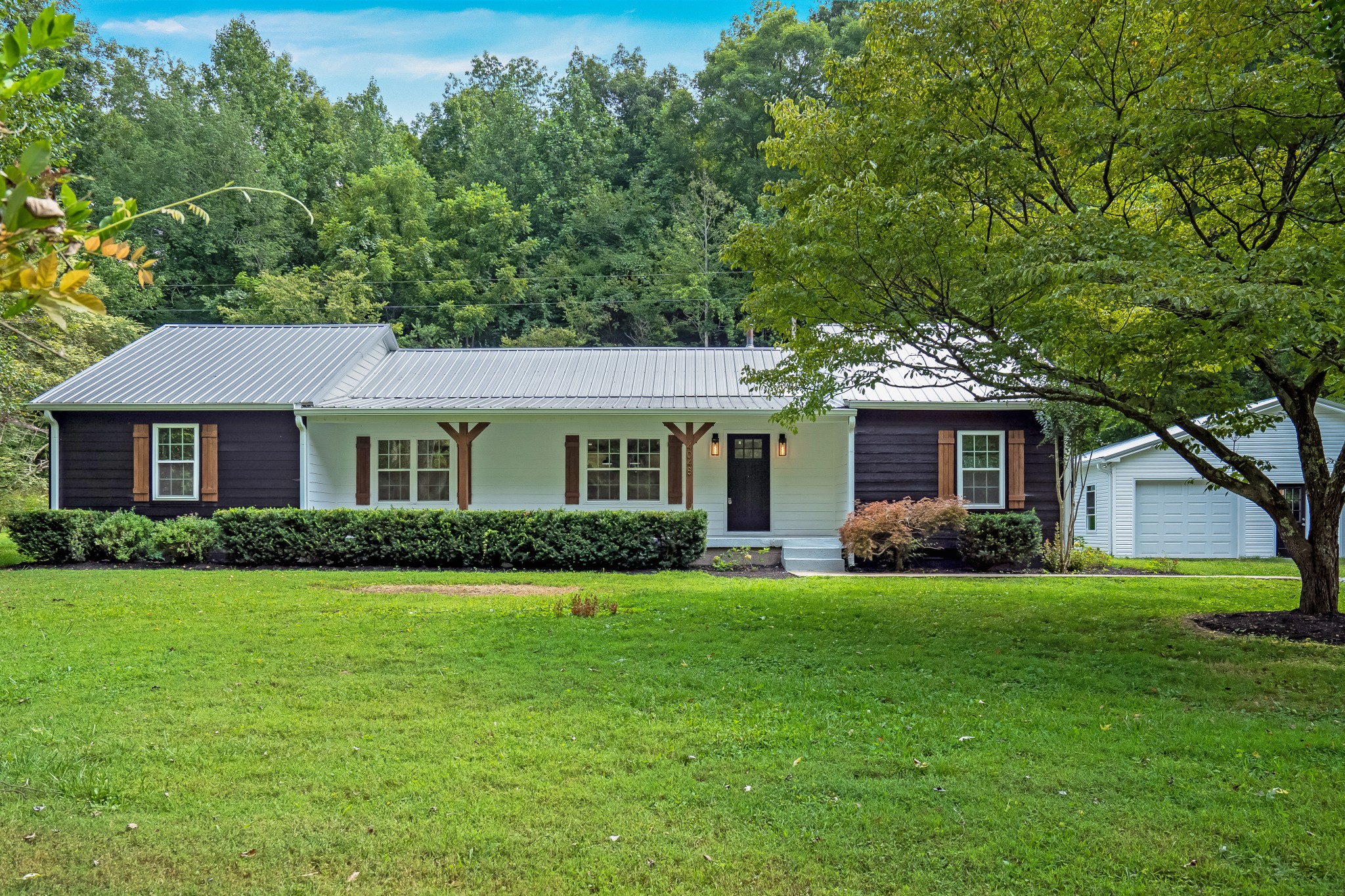 4048 Skelley Road Santa Fe, TN 38482 - Photo 1 of 43 a front view of a house with a garden