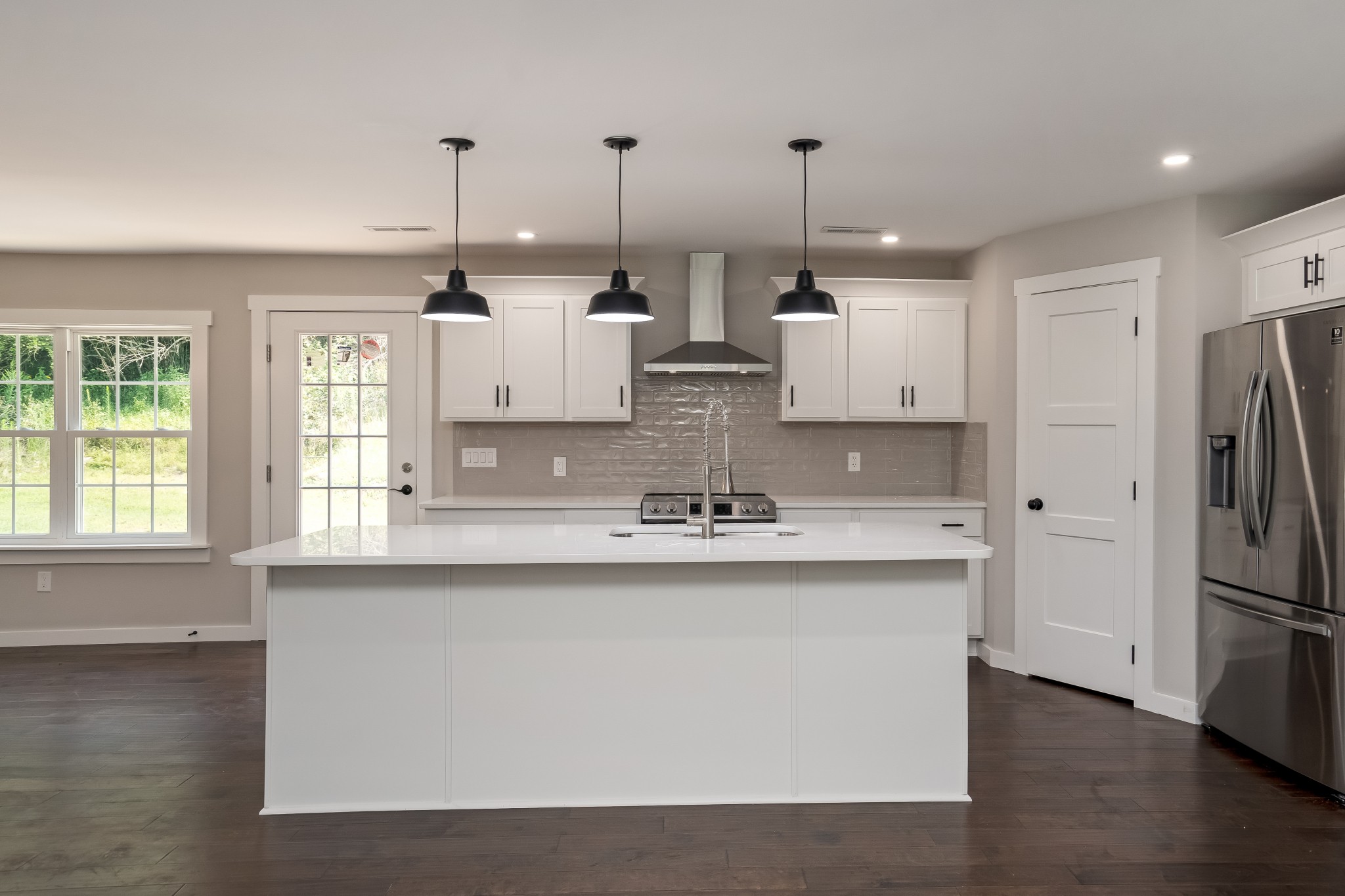 4048 Skelley Road Santa Fe, TN 38482 - Photo 11 of 43 a large kitchen with stainless steel appliances kitchen island granite countertop a refrigerator a sink a stove and a wooden floors
