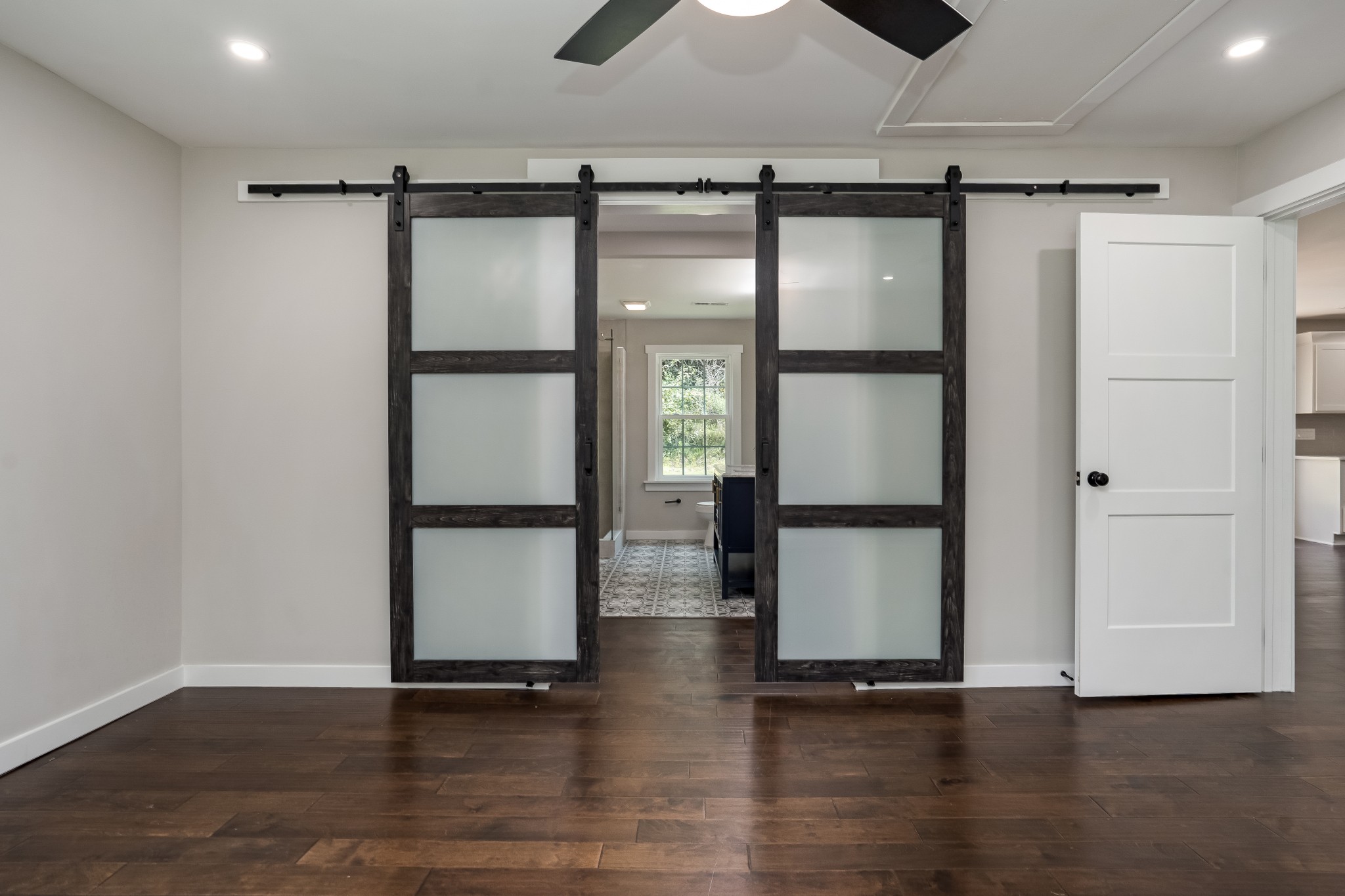 4048 Skelley Road Santa Fe, TN 38482 - Photo 14 of 43 a view of an empty room with wooden floor and a ceiling fan