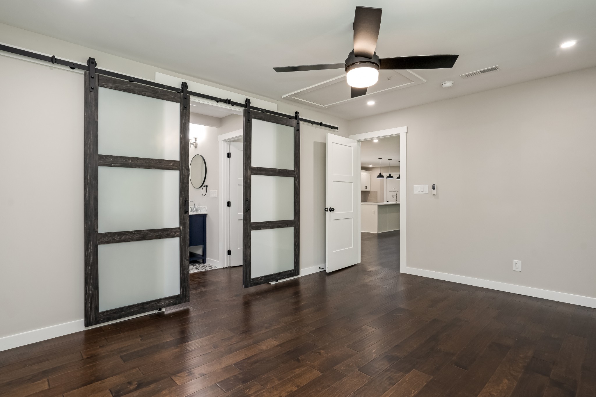 4048 Skelley Road Santa Fe, TN 38482 - Photo 15 of 43 a view of an empty room with wooden floor and a ceiling fan