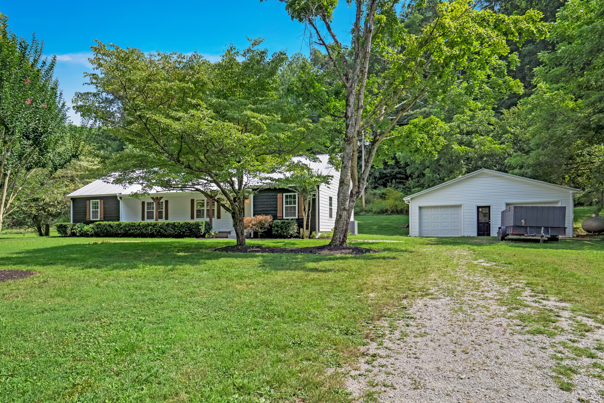 4048 Skelley Road Santa Fe, TN 38482 - Photo 3 of 43 a front view of a house with a garden