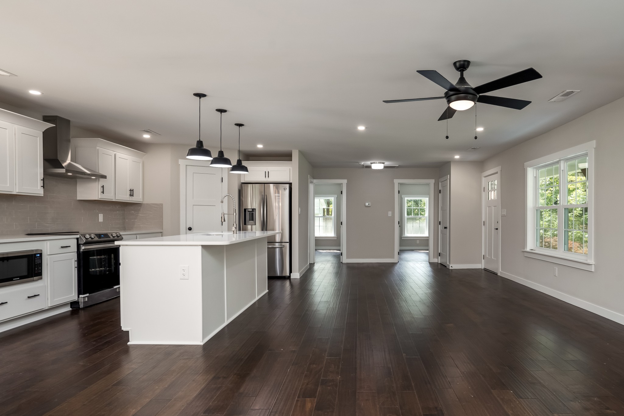 4048 Skelley Road Santa Fe, TN 38482 - Photo 8 of 43 a large kitchen with cabinets wooden floor and stainless steel appliances