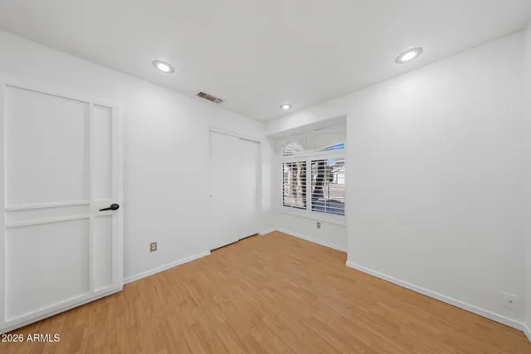 a view of a big room with wooden floor and windows in a room