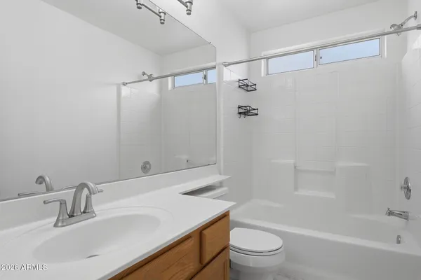 a bathroom with a sink mirror toilet and bathtub