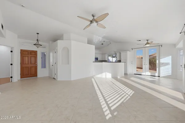 a view of a livingroom with a furniture ceiling fan and window
