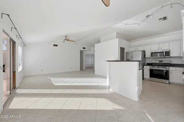 a view of kitchen with furniture and refrigerator