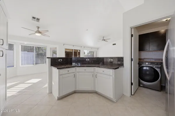 a kitchen with stainless steel appliances granite countertop a sink and cabinets