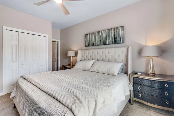 a bedroom with a bed and a night stand