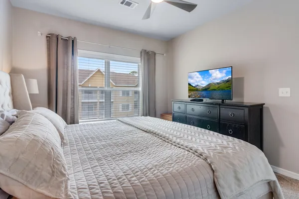 a bedroom with a bed and a flat screen tv