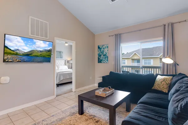 a living room with furniture and a flat screen tv