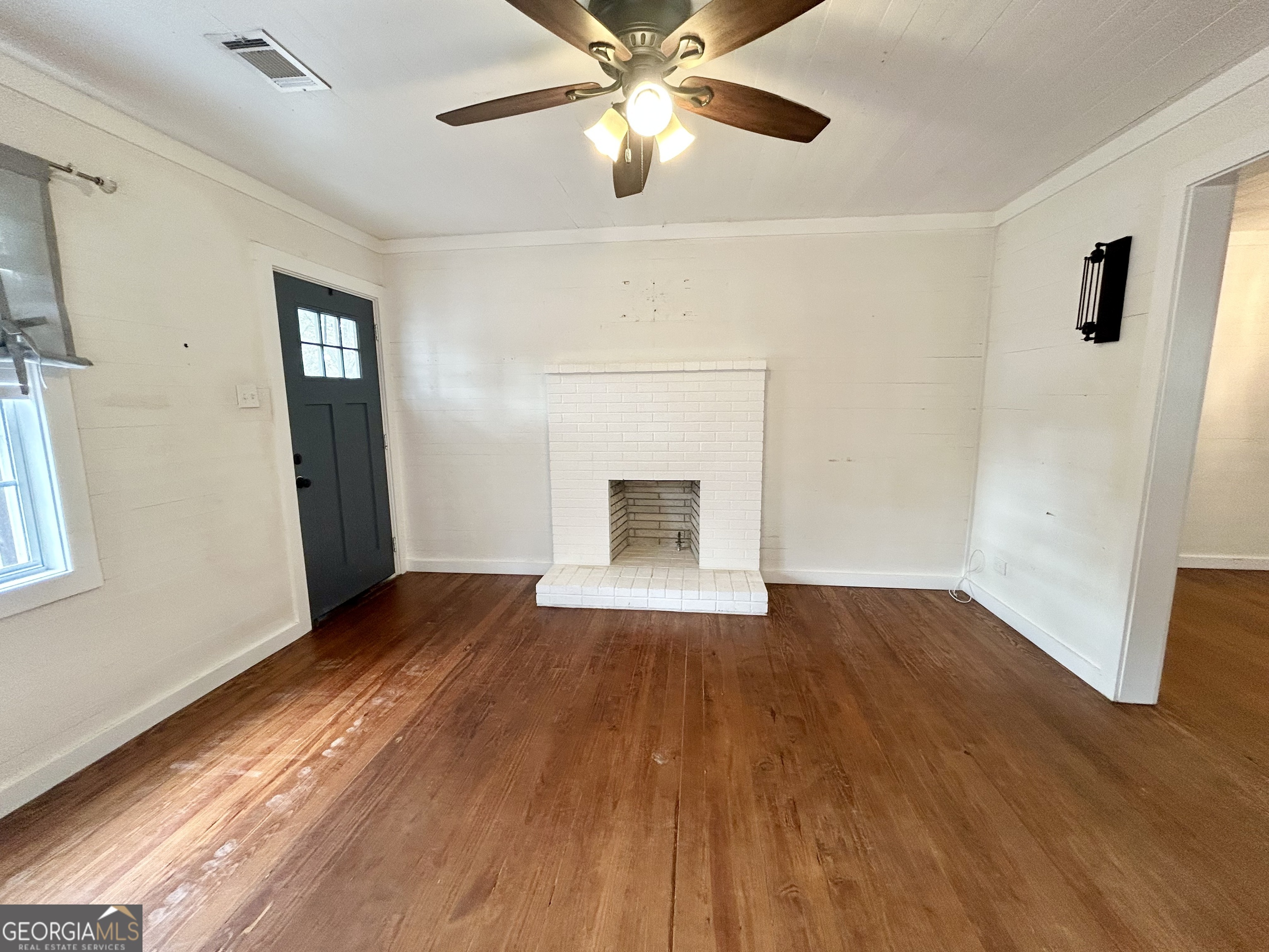 117 Marchman Street Bremen, GA 30110 - Photo 11 of 38 a view of an empty room with wooden floor and a window