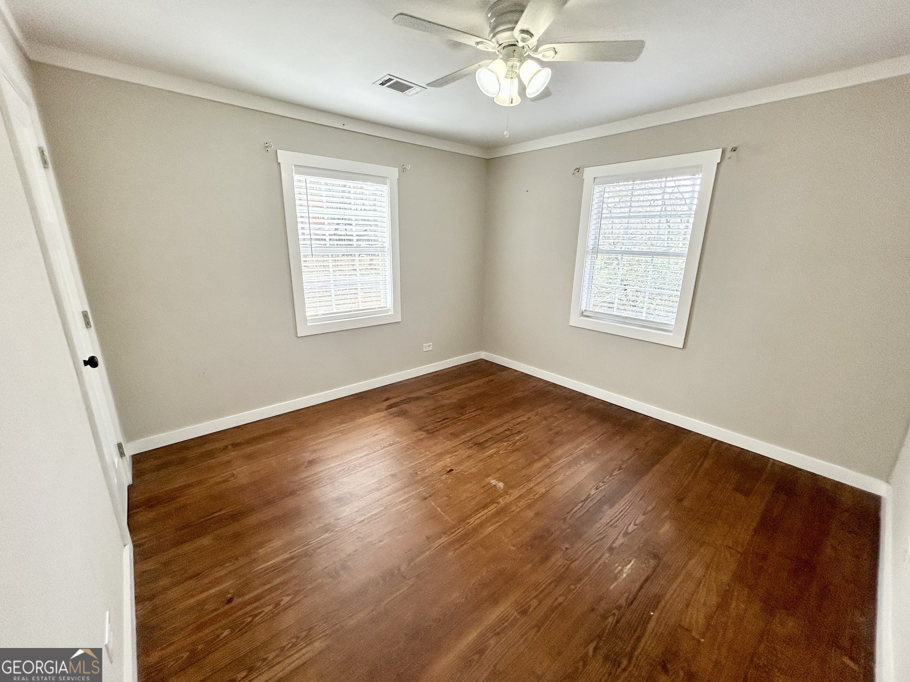 117 Marchman Street Bremen, GA 30110 - Photo 14 of 38 a view of an empty room with wooden floor and a window