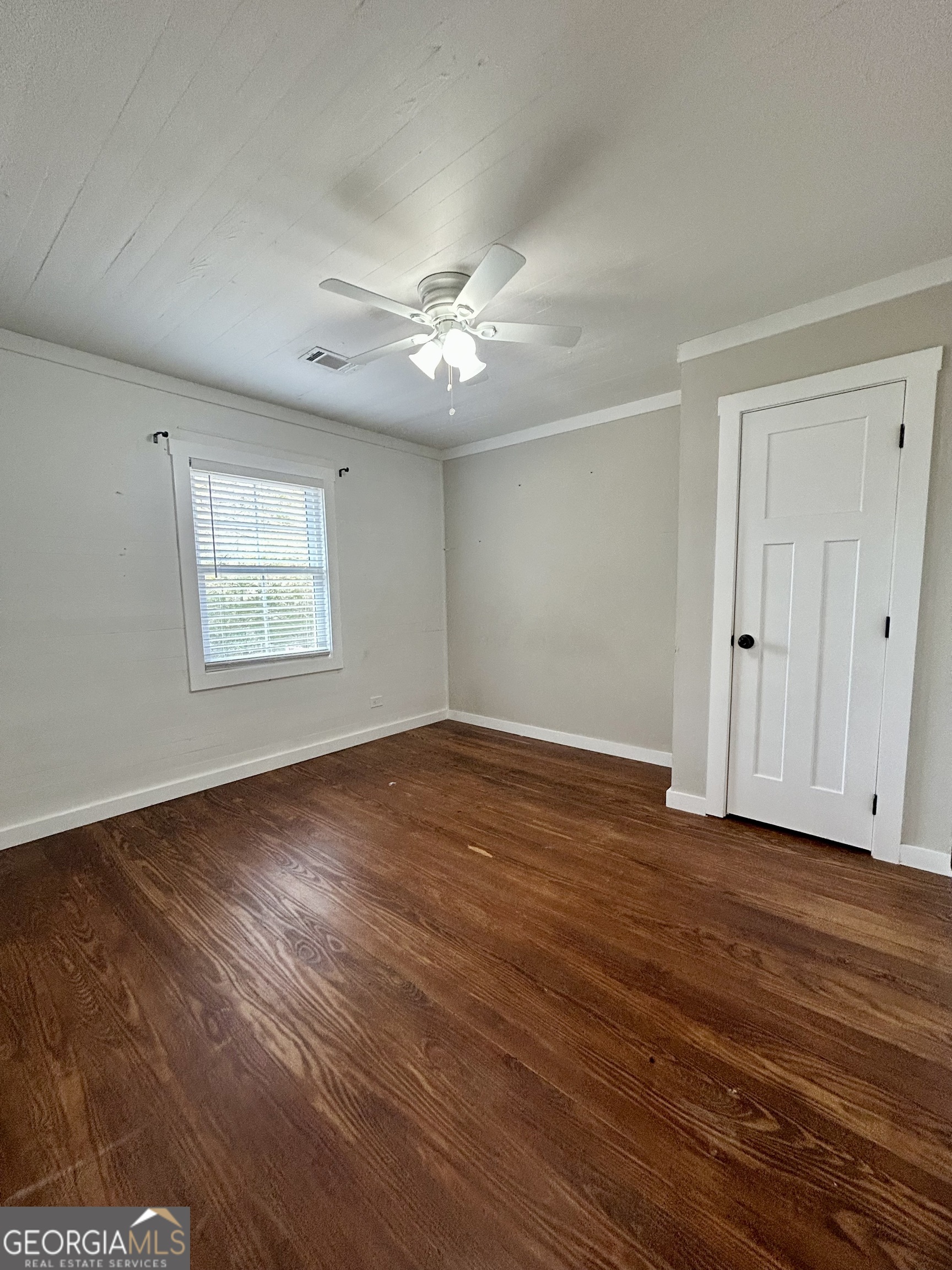 117 Marchman Street Bremen, GA 30110 - Photo 18 of 38 a view of an empty room with wooden floor and a window