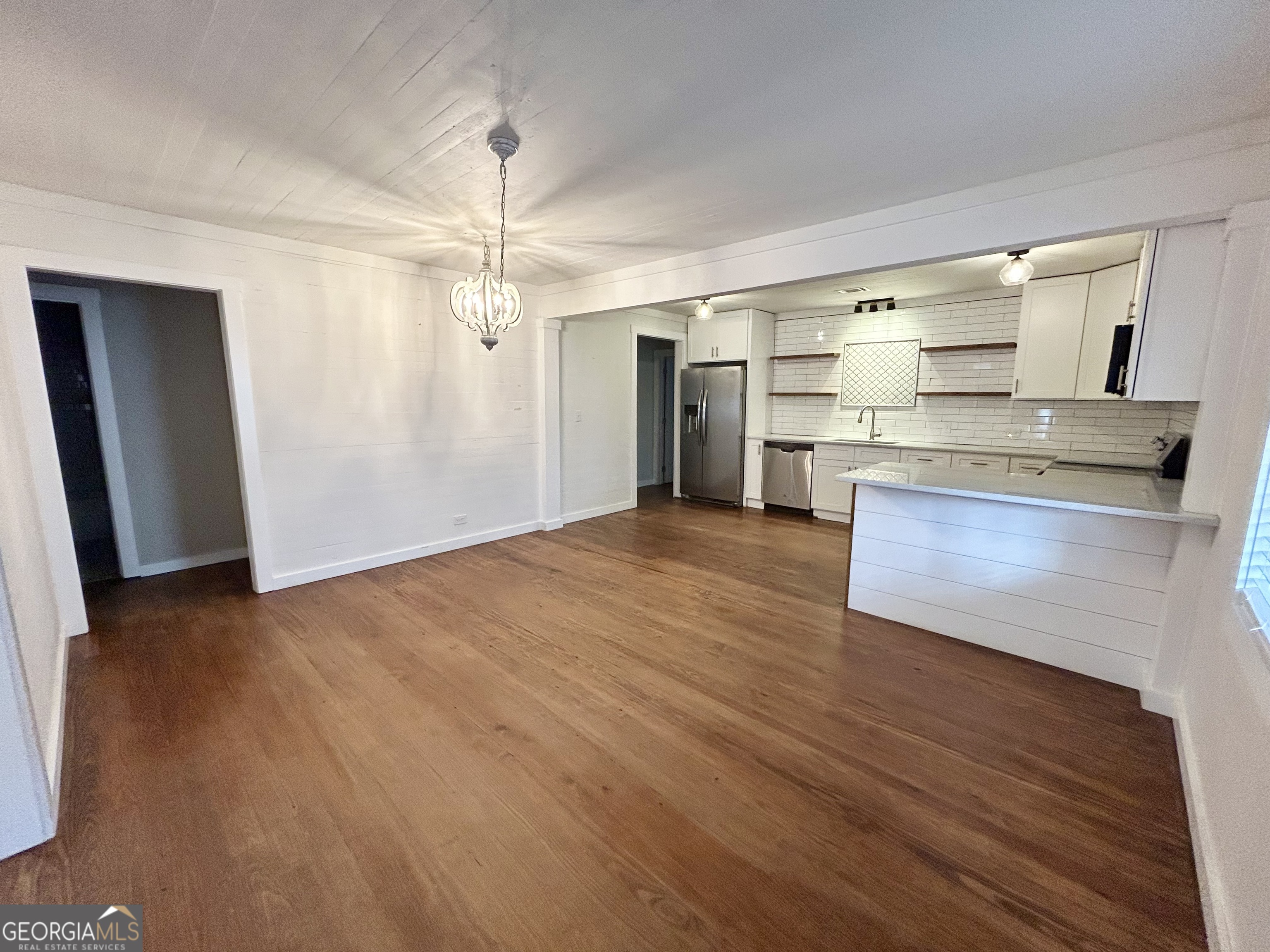 117 Marchman Street Bremen, GA 30110 - Photo 2 of 38 a view of a kitchen with wooden floor and a refrigerator
