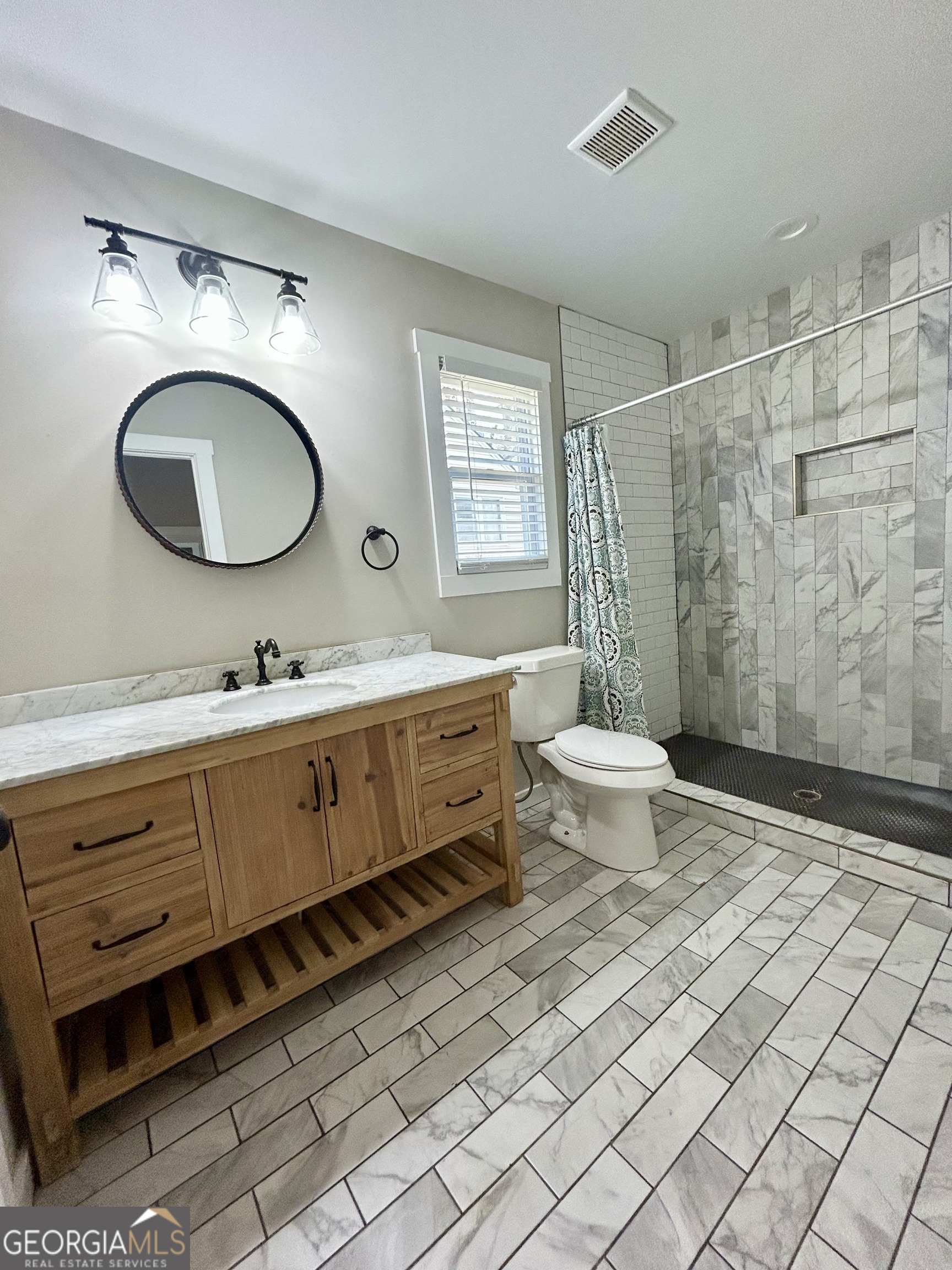 117 Marchman Street Bremen, GA 30110 - Photo 29 of 38 a bathroom with a double vanity sink mirror and toilet