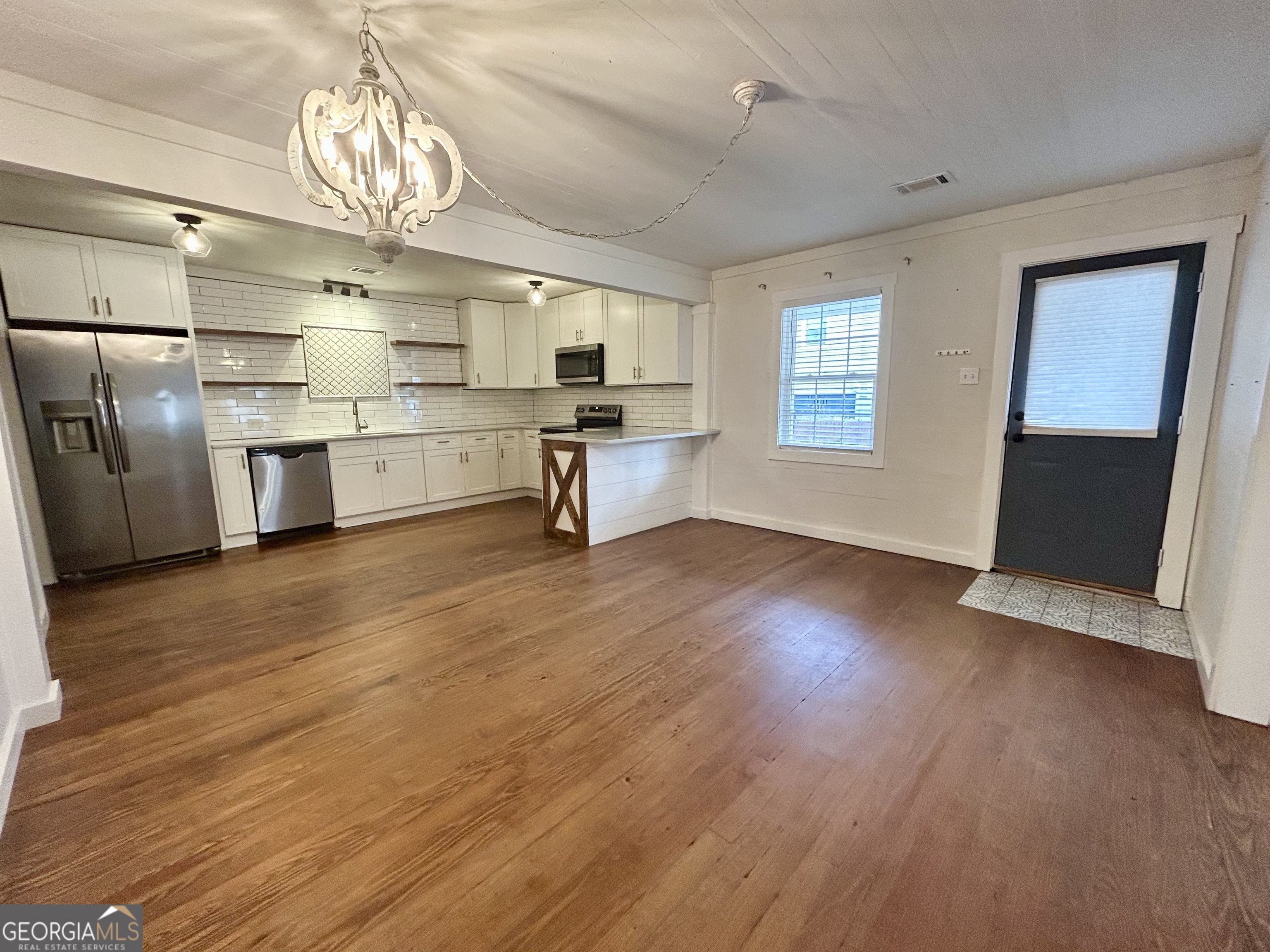 117 Marchman Street Bremen, GA 30110 - Photo 8 of 38 a large kitchen with stainless steel appliances a large counter top a stove and a chandelier