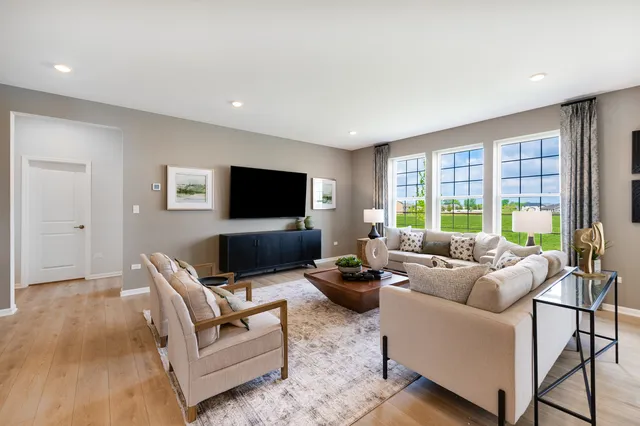 a living room with furniture a large window and a flat screen tv