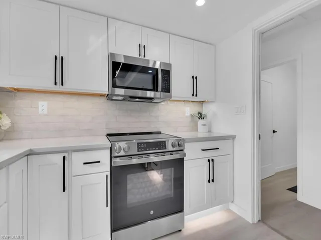 a kitchen with stainless steel appliances white cabinets and a sink